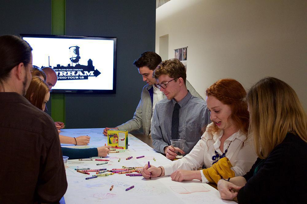 AIGA tour attendees draw cacti at the Caktus Group office.