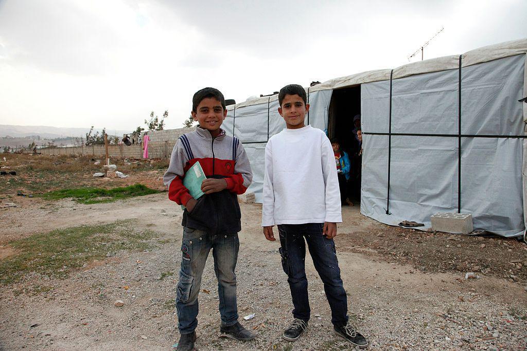 Muhanad and Ahmad*, two Syrian refugee boys outside Ahmad's temporary home, in Lebanon's Bekaa Valley.