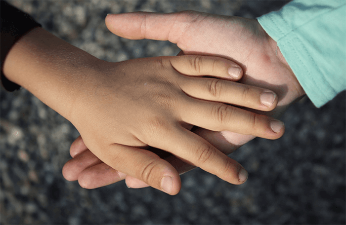 Two children holding hands