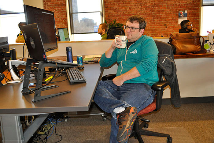 Developer Jeremy Gibson sits back for a moment at his desk.