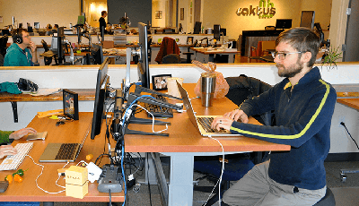 Developer and blog author Dmitriy Chukhin codes at his desk in the Caktus office