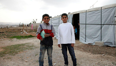 Muhanad and Ahmad*, two Syrian refugee boys outside Ahmad's temporary home, in Lebanon's Bekaa Valley.