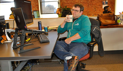 Developer Jeremy Gibson sits back for a moment at his desk.